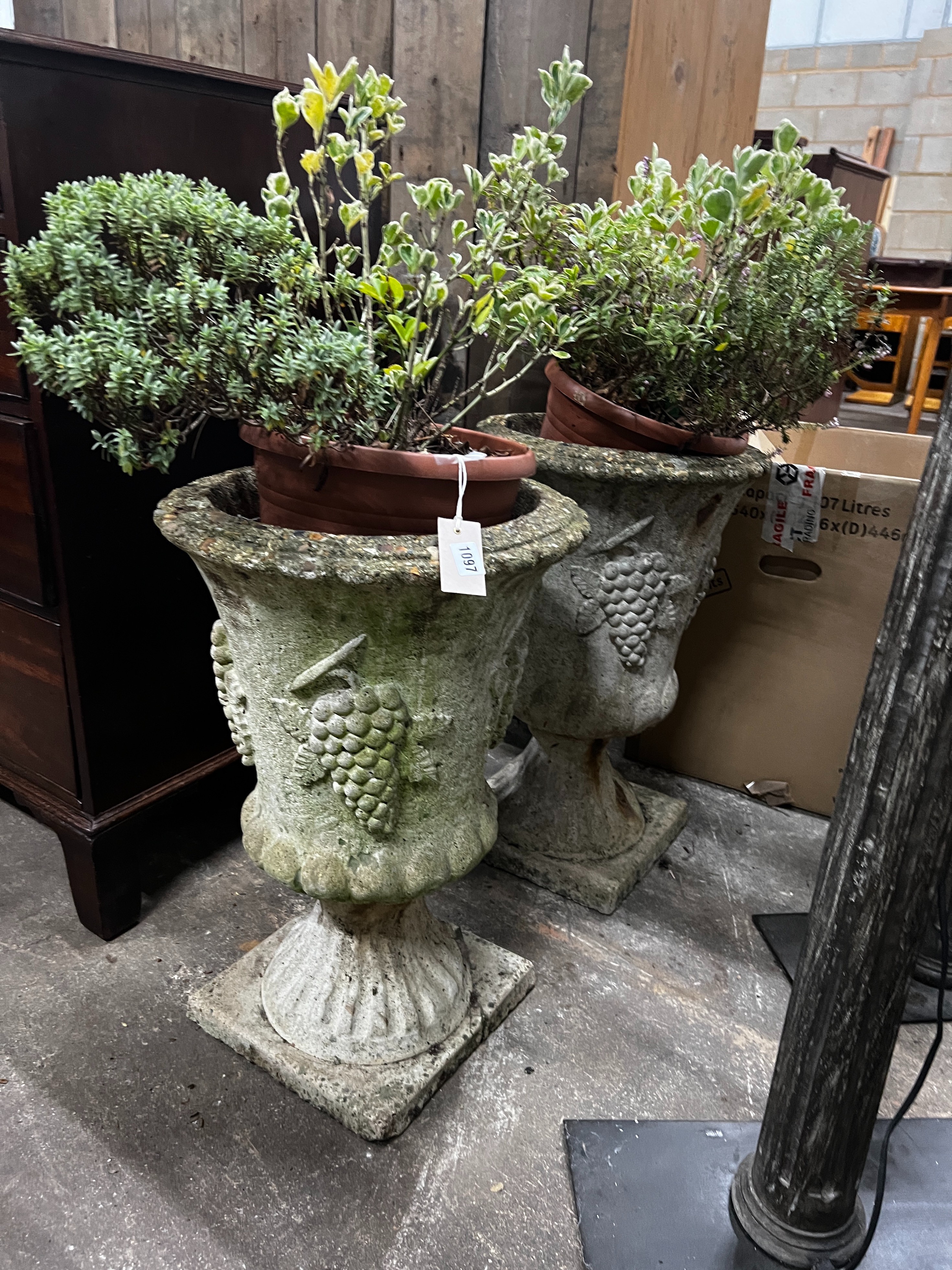 A pair of reconstituted stone circular garden planters, diameter 36cm, height 60cm